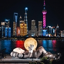 32-Meter Companion By KAWS Lifts Glowing Moon Along Abu Dhabi's Waterfront